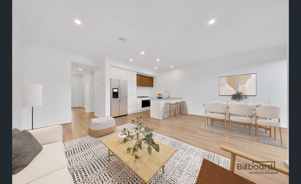 Open plan living and dining space with modern furniture, timber flooring, minimalist decor and contemporary kitchen in a Melbourne home.