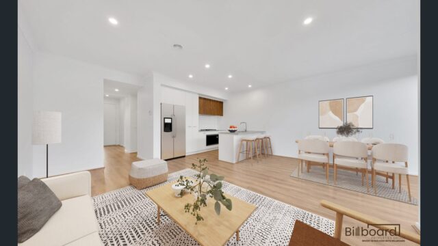 Open plan living and dining space with modern furniture, timber flooring, minimalist decor and contemporary kitchen in a Melbourne home.