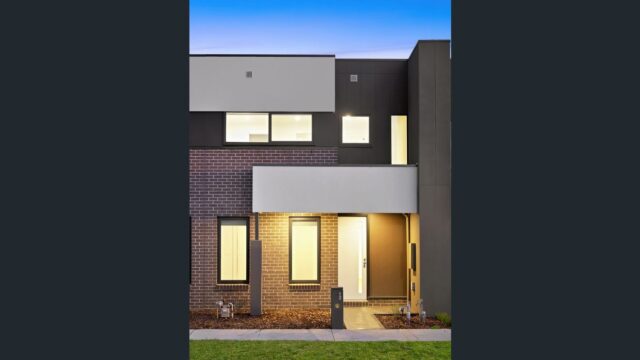 Modern double-storey townhouse exterior with brick and render finish, illuminated entry and contemporary architectural design in Wollert.