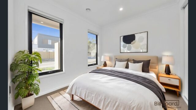 Beautifully styled bedroom with modern decor, indoor plant, natural light and neutral colour palette in a Melbourne home.