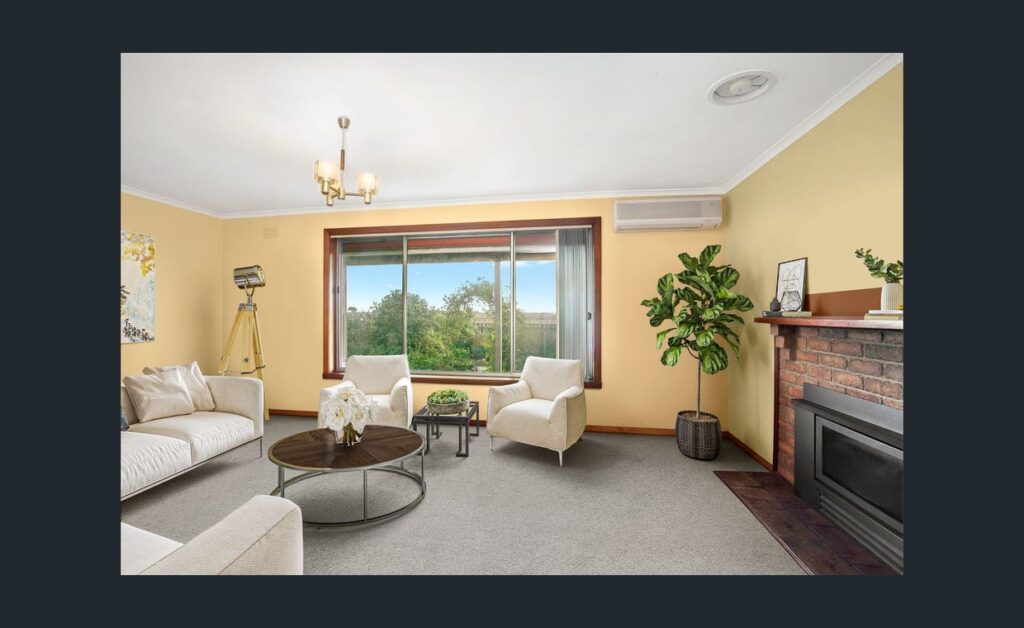 Spacious living room with fireplace, modern furniture, indoor plant and large window overlooking green countryside views.